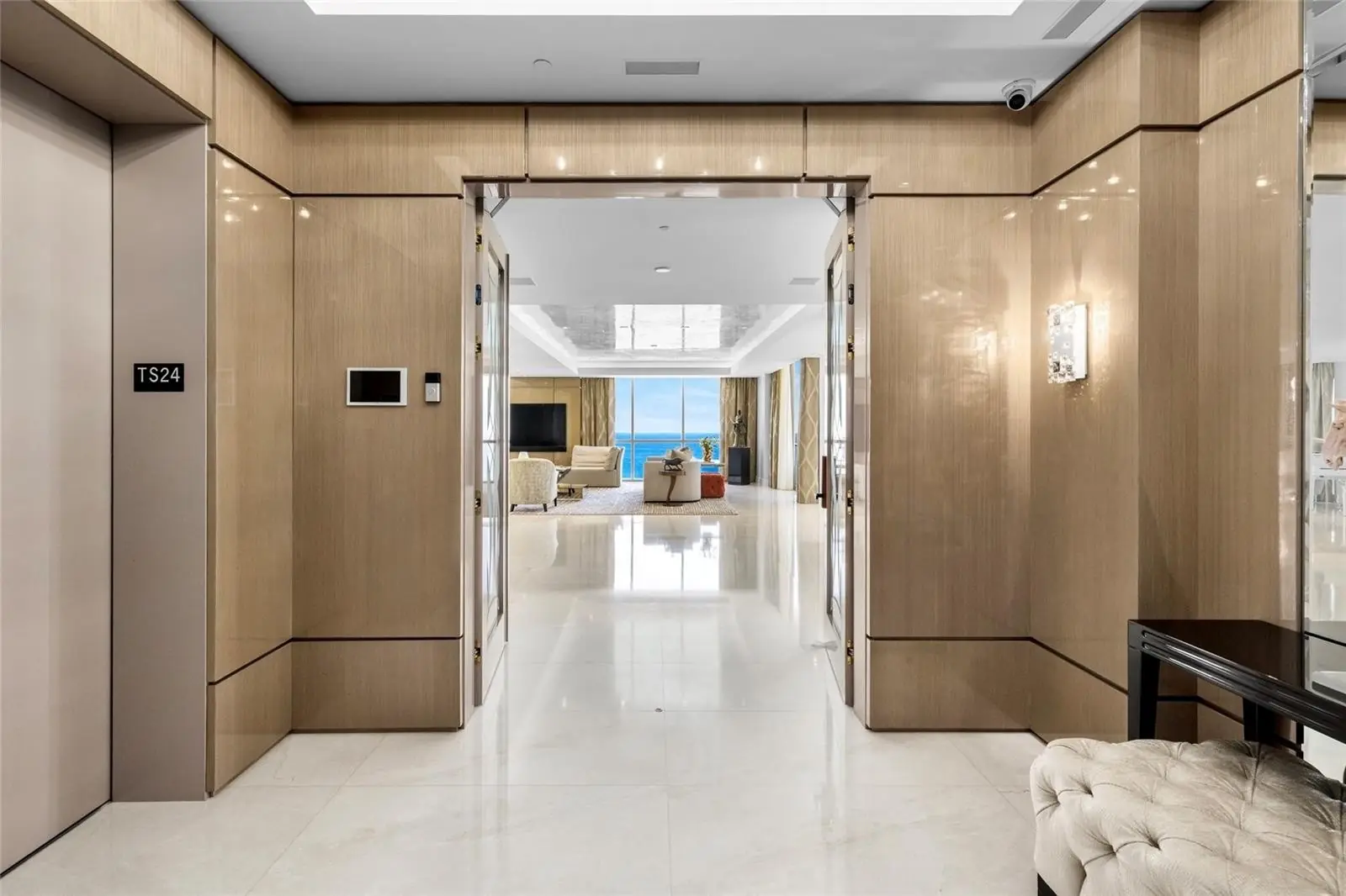 Oceanfront condo living and dining area with floor-to-ceiling windows overlooking the ocean